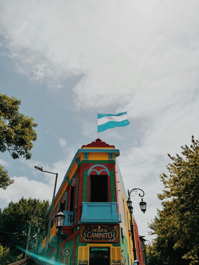 Colorful Caminito building in La Boca, Buenos Aires, with an Argentine flag