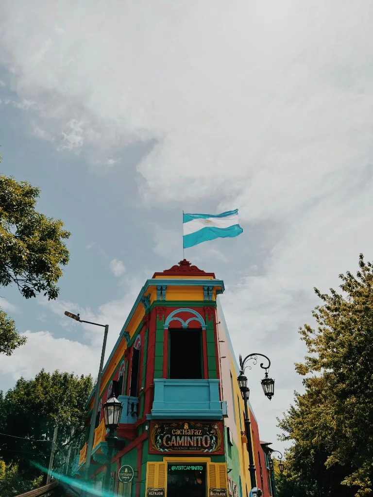 Colorful Caminito building in La Boca, Buenos Aires, with an Argentine flag