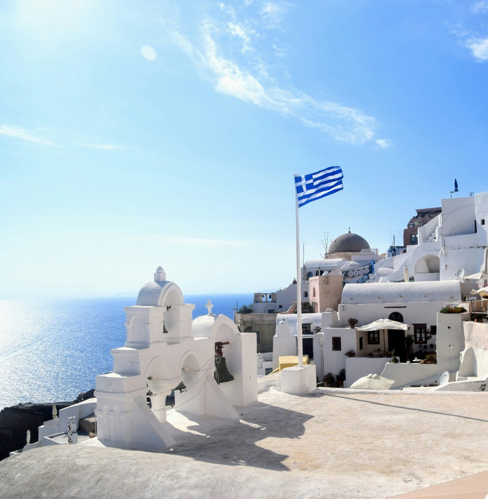Greek flag in Santorini representing the Greece Golden Visa