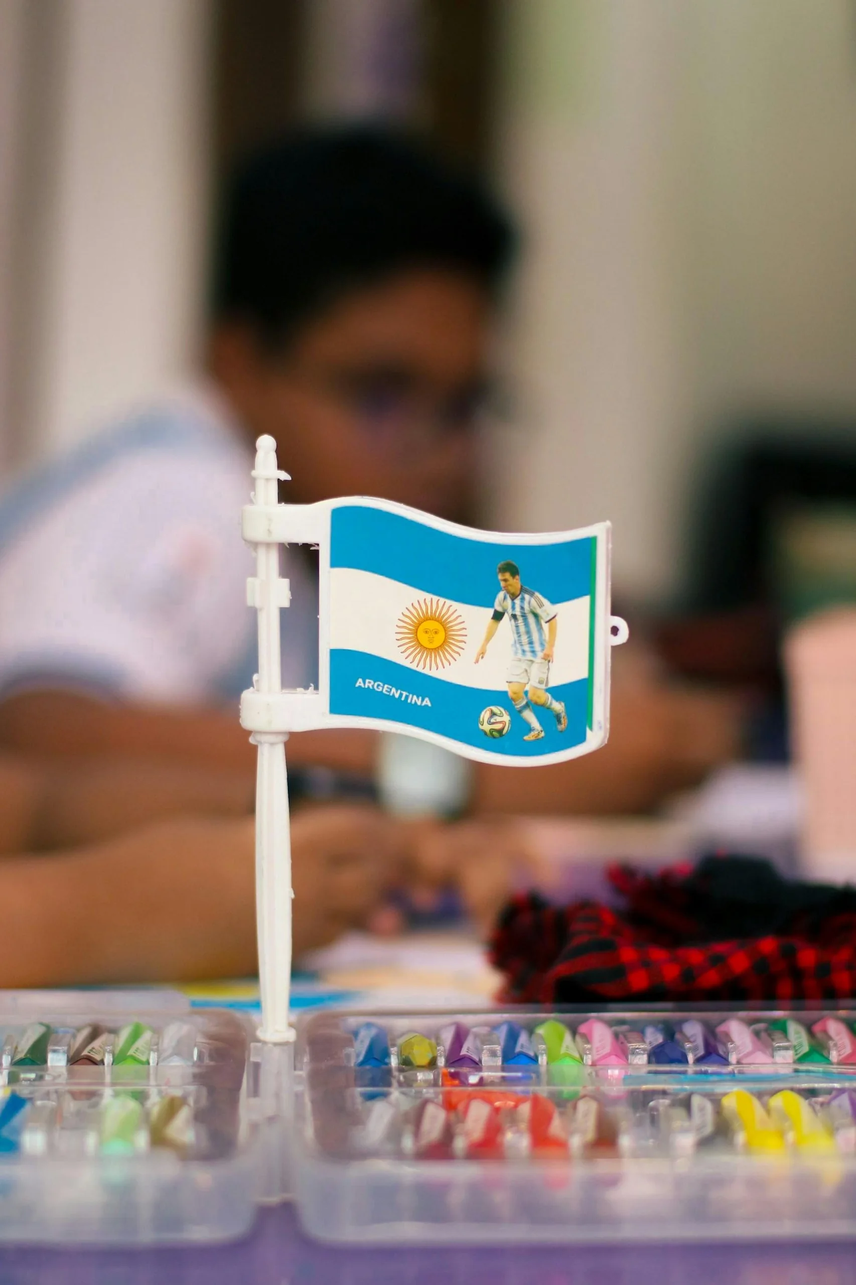 Argentine flag photographed from a low angle against a blue sky