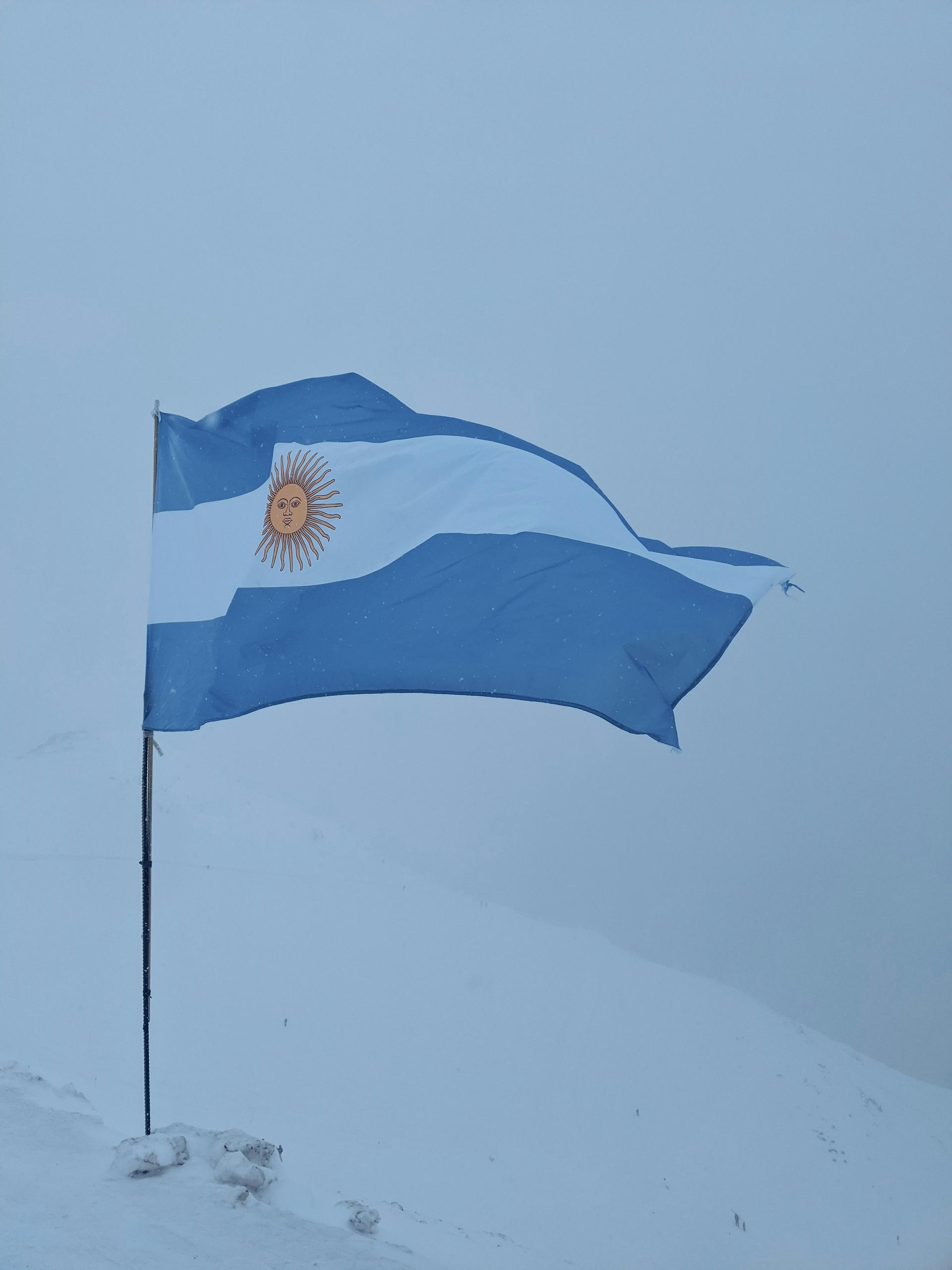 Argentine flag amid the snow-capped Andes