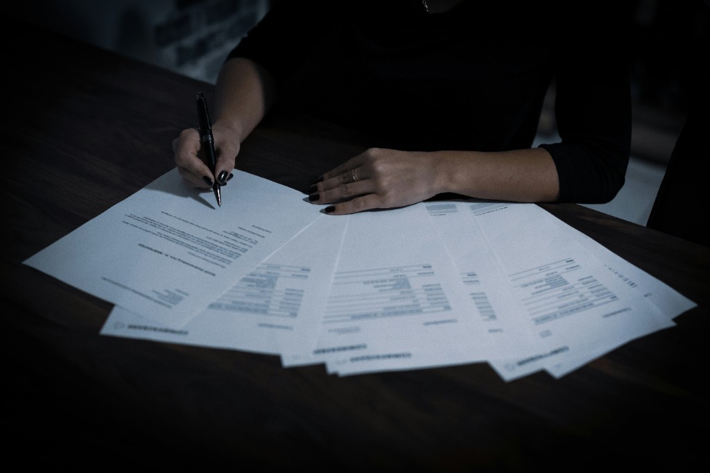 Person reviewing printed documents at a desk